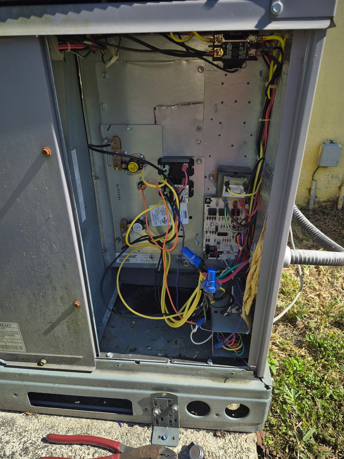 Open condenser control cabinet during an electrical and refrigerant inspection